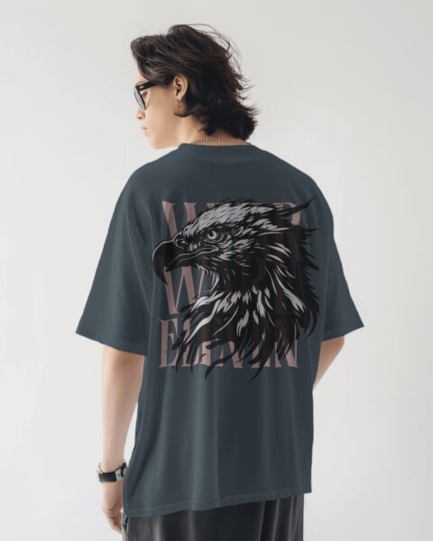 Person wearing a dark gray t-shirt with an eagle design on the back, standing against a plain background.