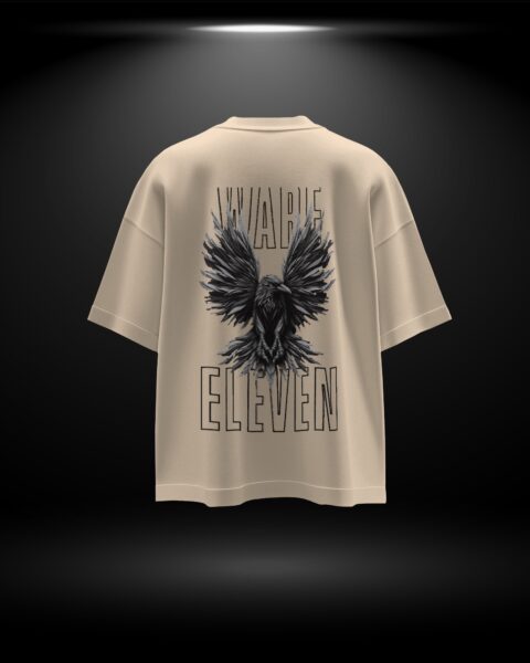 Beige t-shirt with black eagle design and 'ELEVEN' text on a dark background