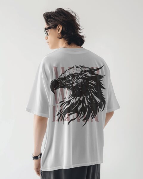 Person wearing a white t-shirt with an eagle design on the back against a plain background