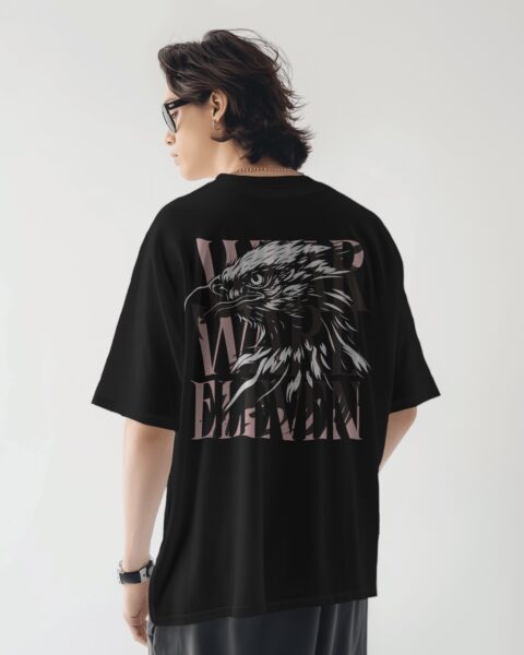 Person wearing a black t-shirt with an eagle design on the back against a white background