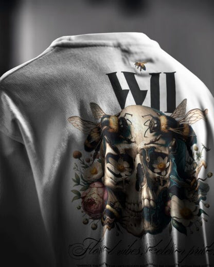 White shirt with a skull and floral design on a dark background